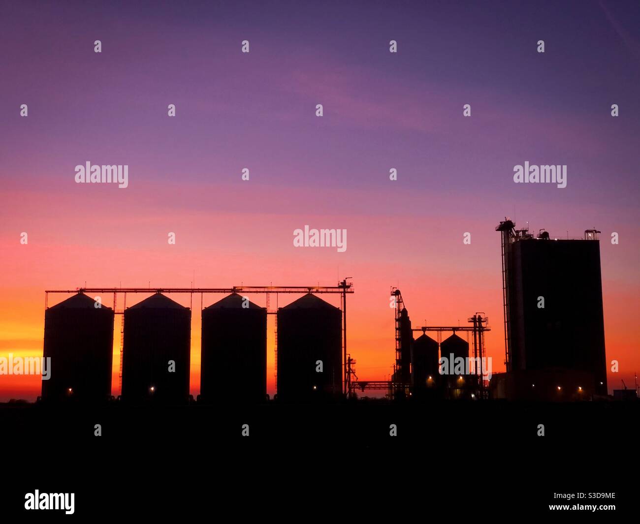Silhouettes of factories at dusk - Smartphone Captured Stock Image