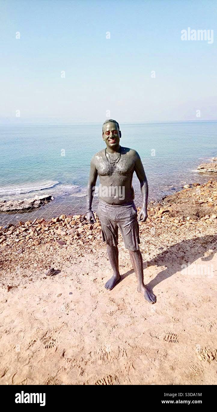 A tourist in Amman Jordon at Dead Sea beach standing after