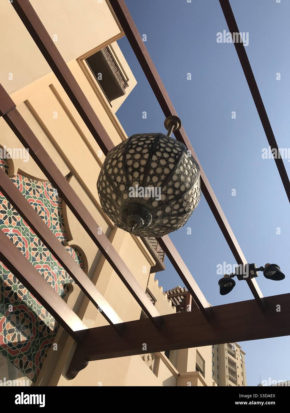 Arabic style outdoor pendant lamp hanging outside a building in Doha, Qatar - Smartphone Captured Stock Image