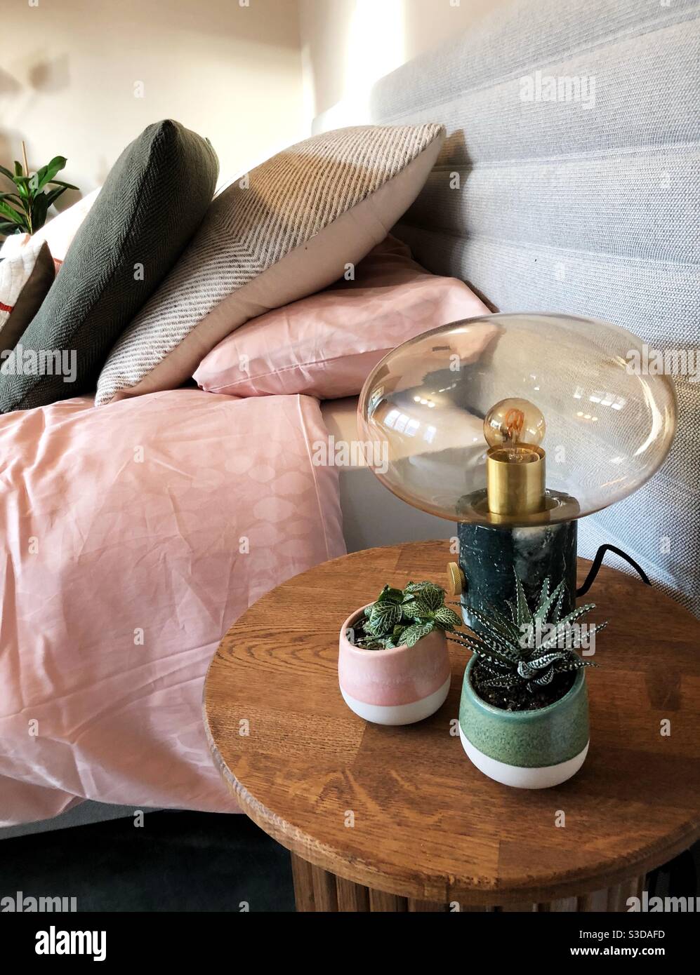 Bedside table in a cozy bedroom Stock Photo
