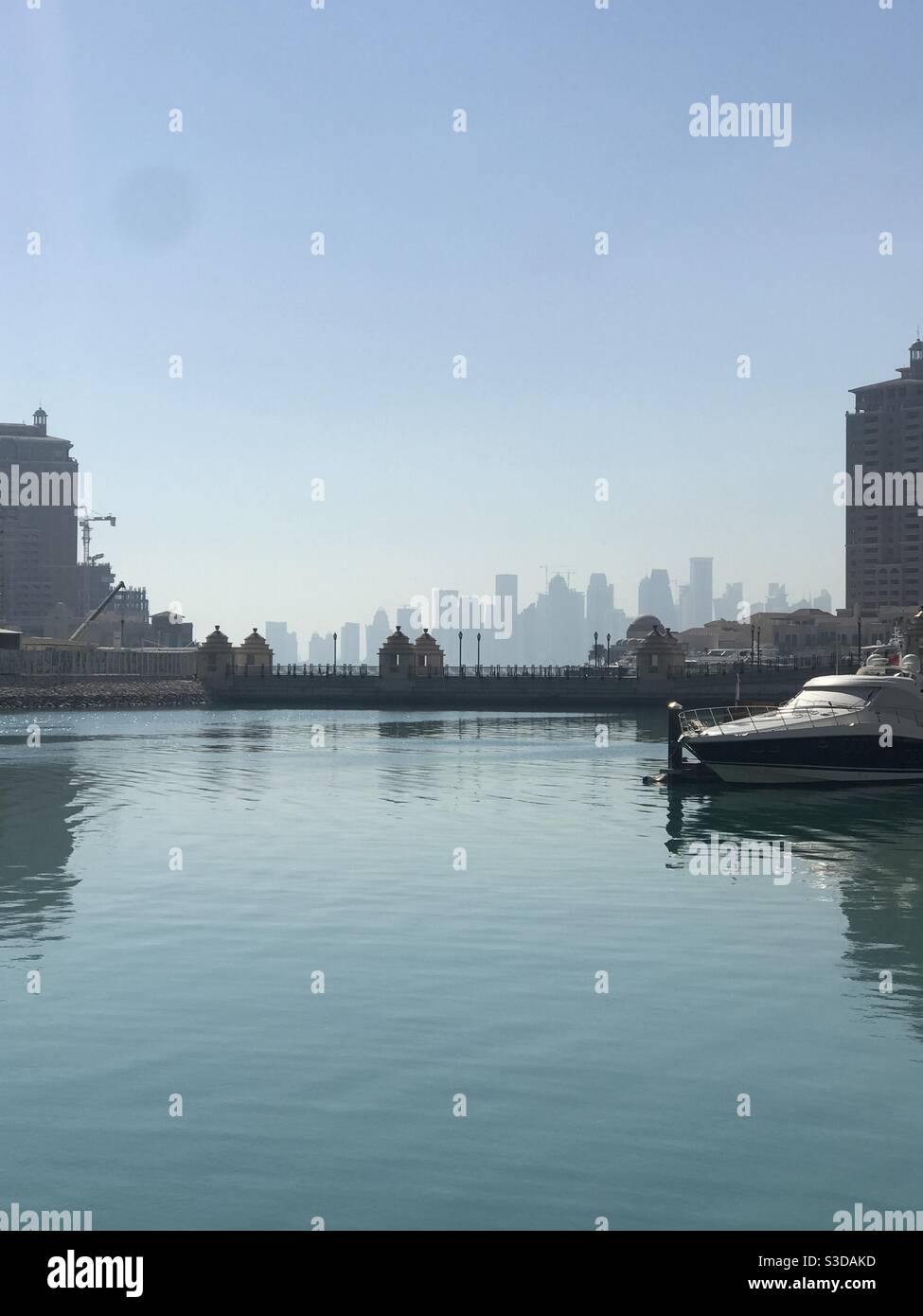 Porto Arabia on the artificial island of The Pearl, Qatar, with a view of the Doha skyline in the background - Smartphone Captured Stock Image