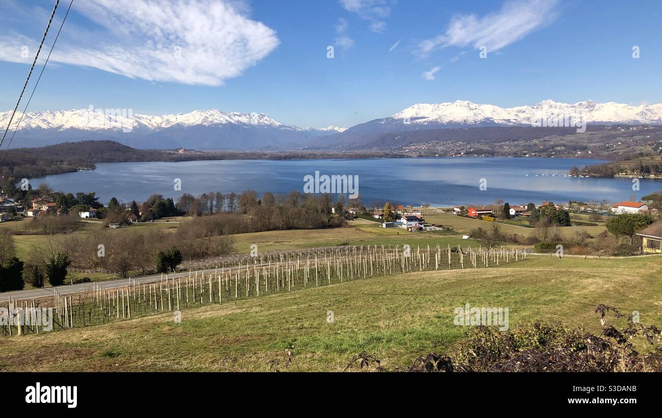 Landscape View of Lake Viverone in the Biella Biellese region of Piemonte Piedmont Italy surrounded by mountains with snow Stock Photo