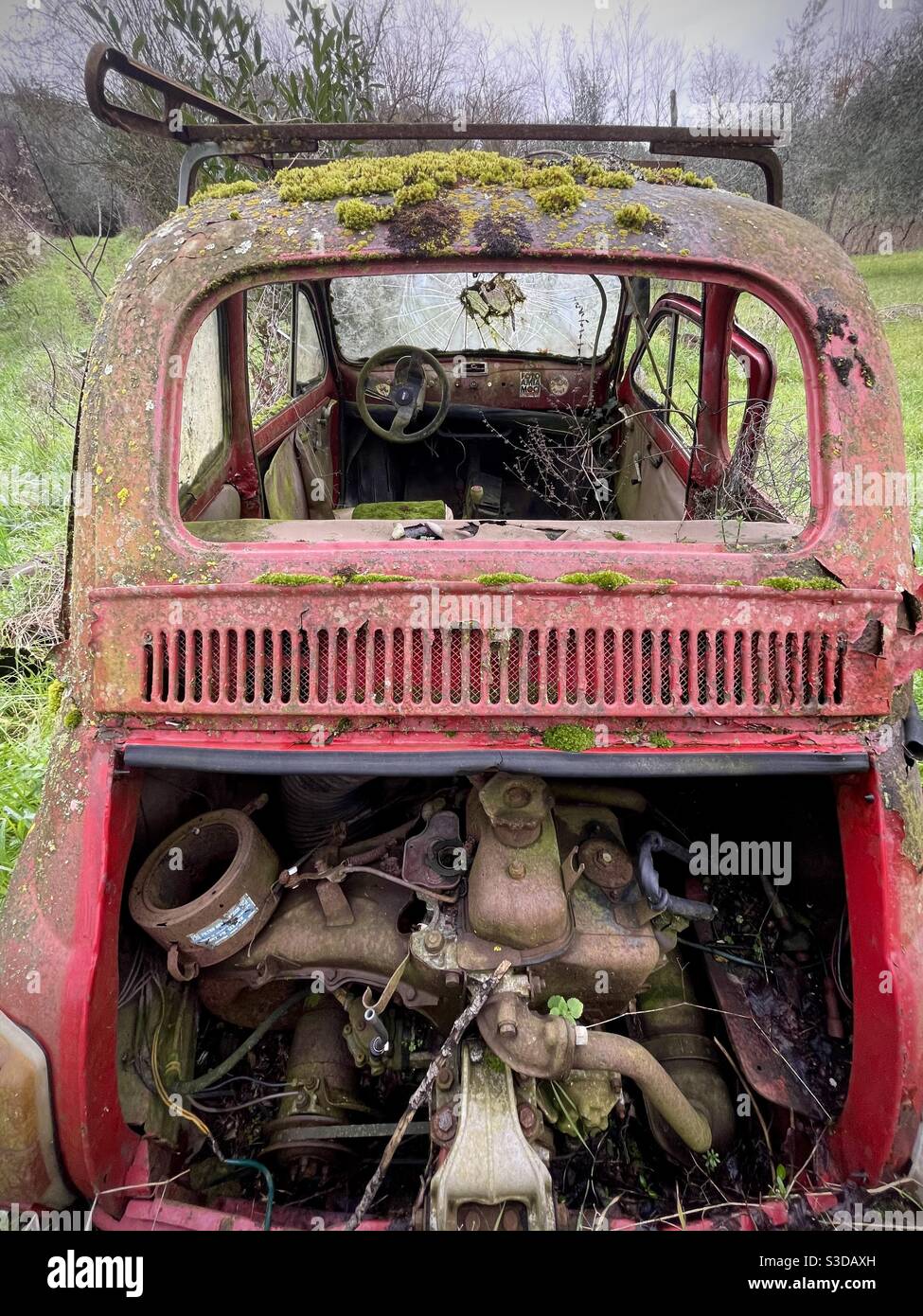 Old abandoned Fiat 500 car abandoned in a rural area in Tuscany Italy Stock Photo