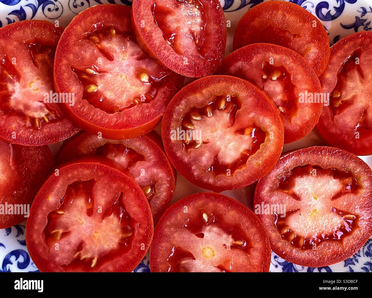 Sliced tomatoes in a vintage bowl Stock Photo