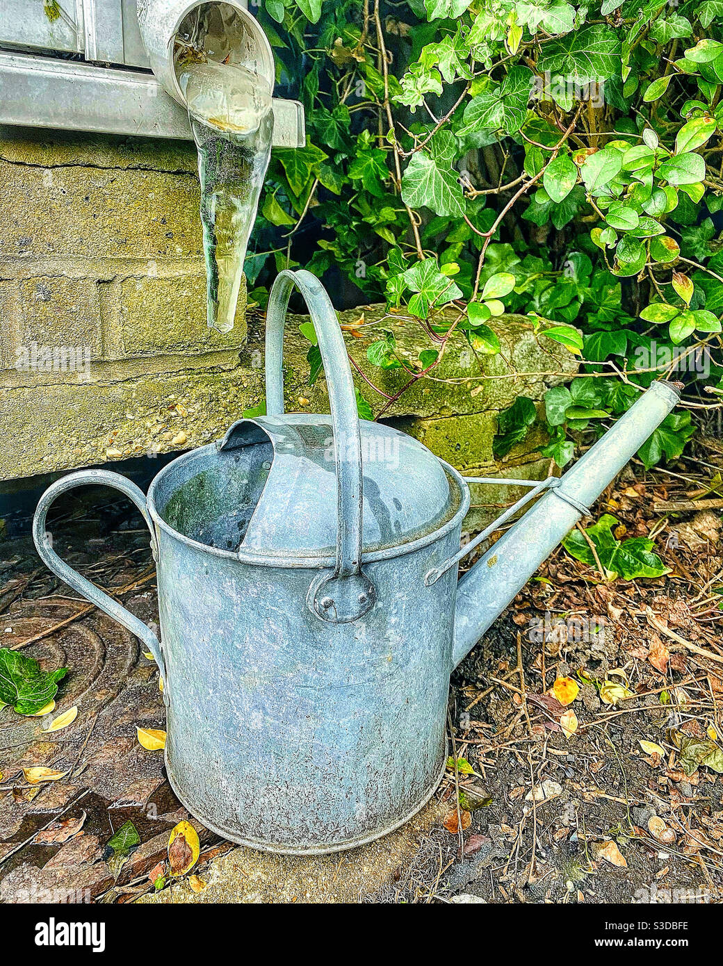Icicle and watering can. - Smartphone Captured Stock Image