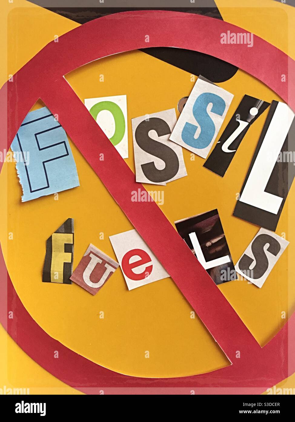 Cancel fossil fuels using cut out paper letters in the ransom note typography inside the international no symbol, USA - Smartphone Captured Stock Image