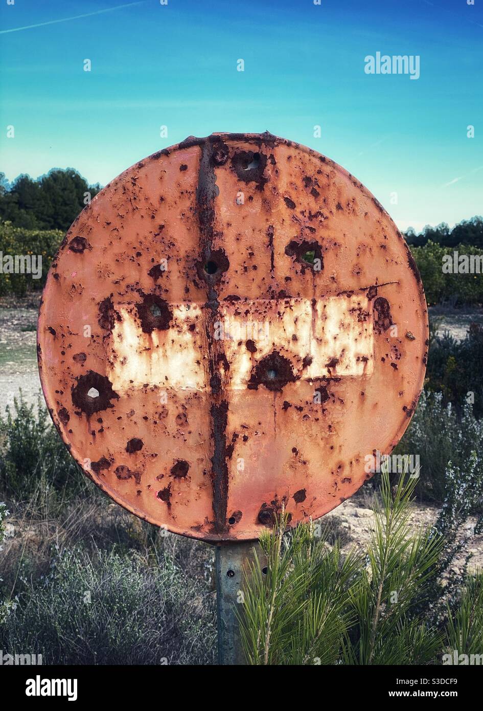 Grungy no entry traffic sign with bullet holes on it Stock Photo