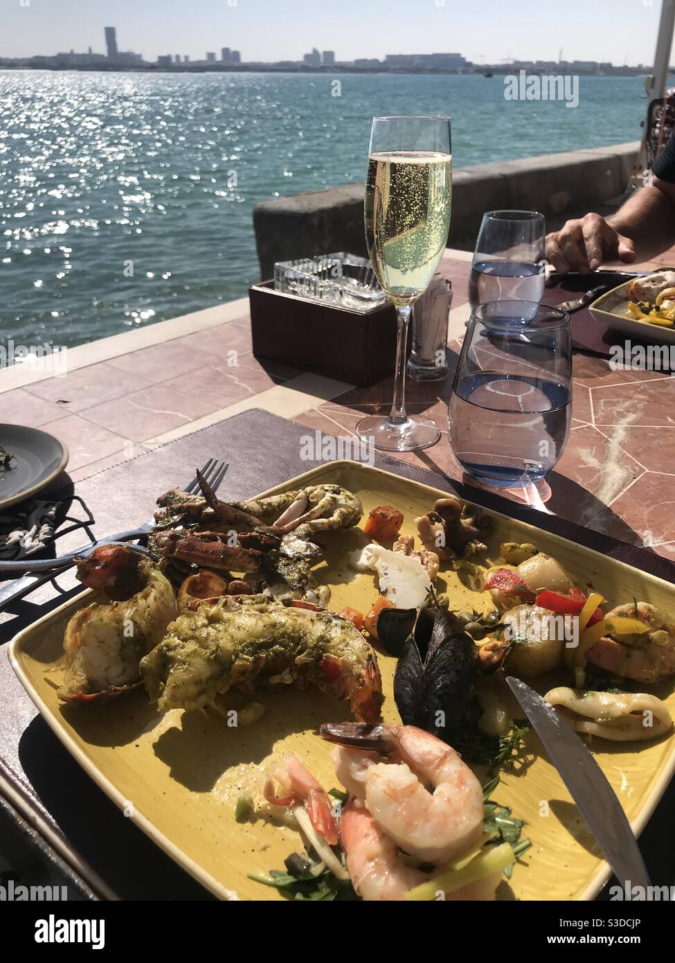 Friday brunch on an outdoor terrace by the sea - Smartphone Captured Stock Image