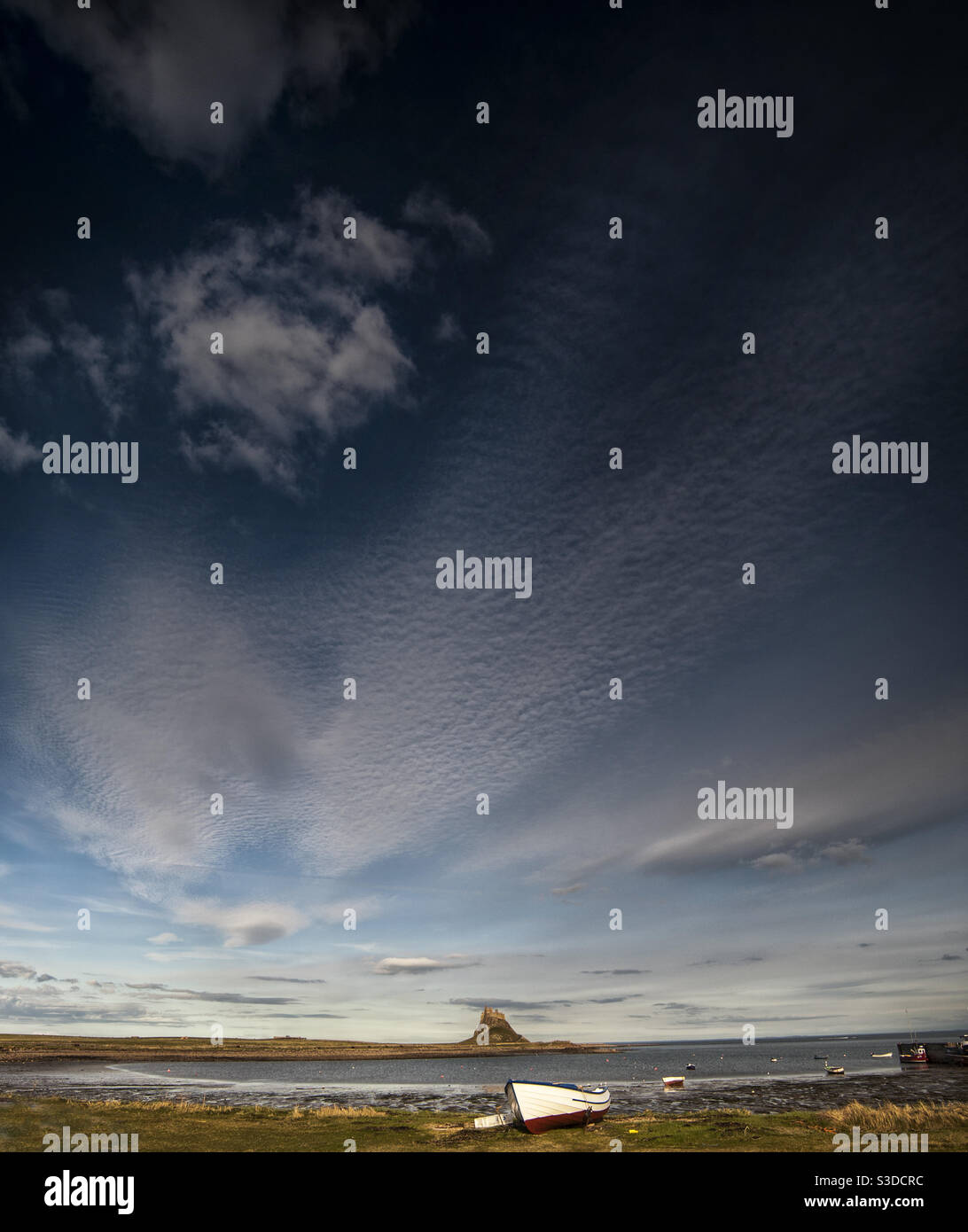 Huge sky over lindisfarne castle (Holy Island) on the Northumbrian coast Stock Photo