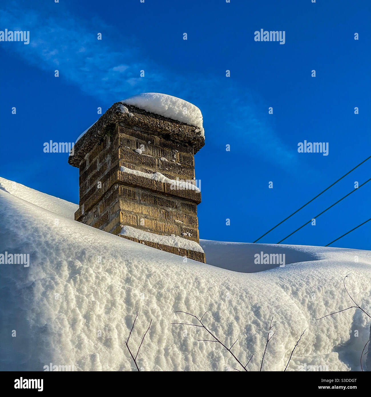 Chimney and heavy snow on roof. Stock Photo