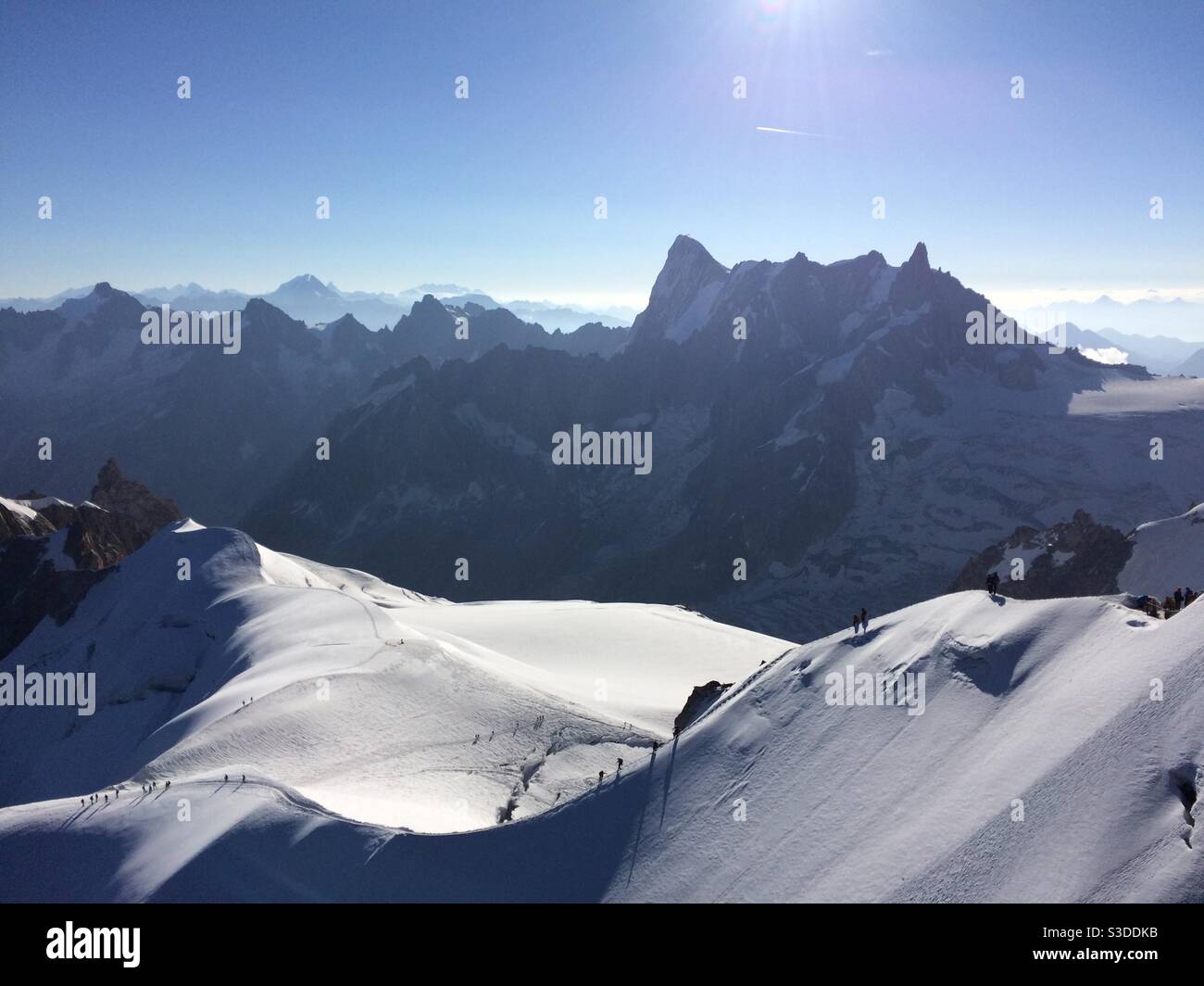 Mountaineers walking down the sheer Aiguille du midi arête, Chamonix, France, Europe Stock Photo