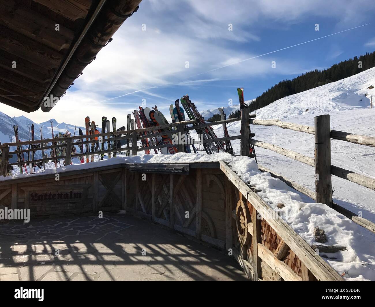 Skis stored against a chalet fence in the snow Stock Photo Alamy