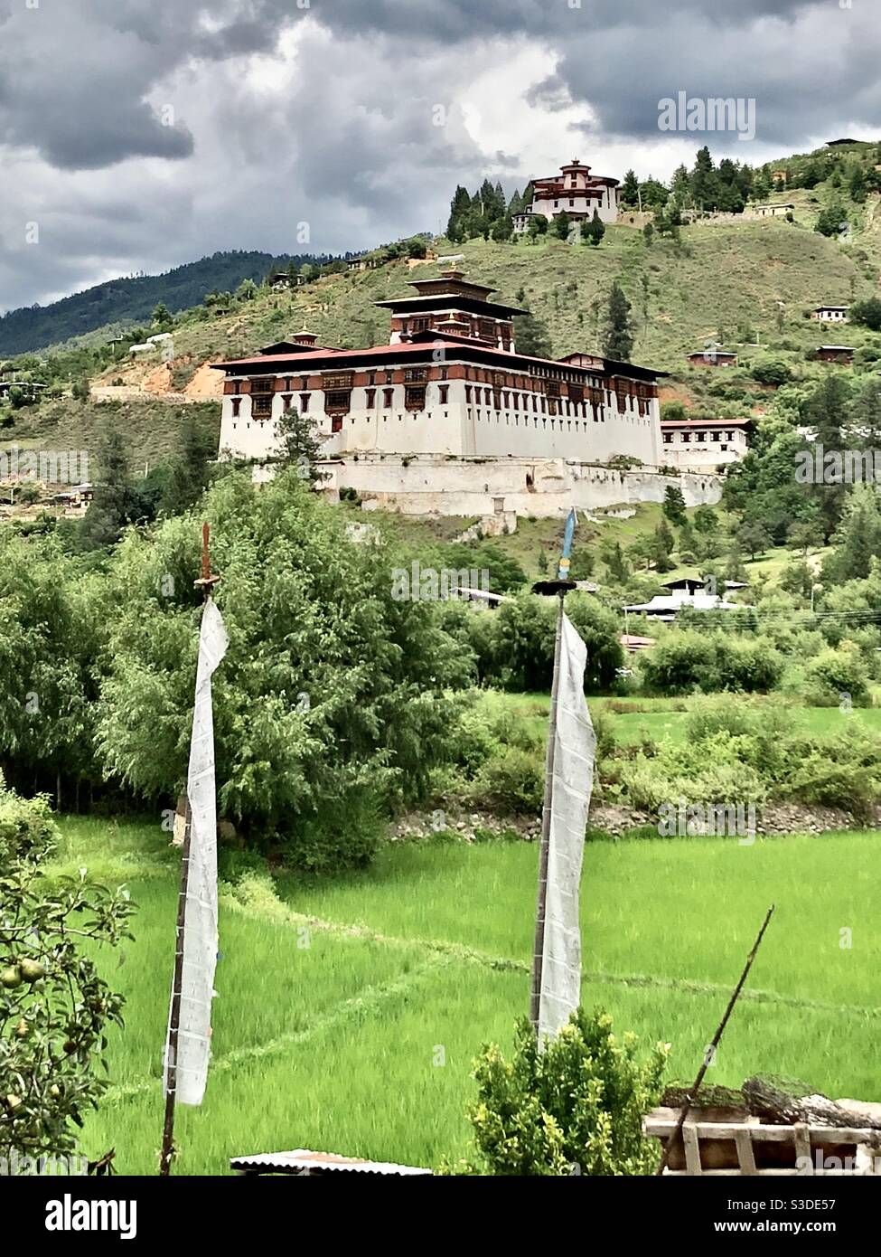 Rinpung Dzong and prayer flags in Paro valley, Bhutan - Smartphone Captured Stock Image