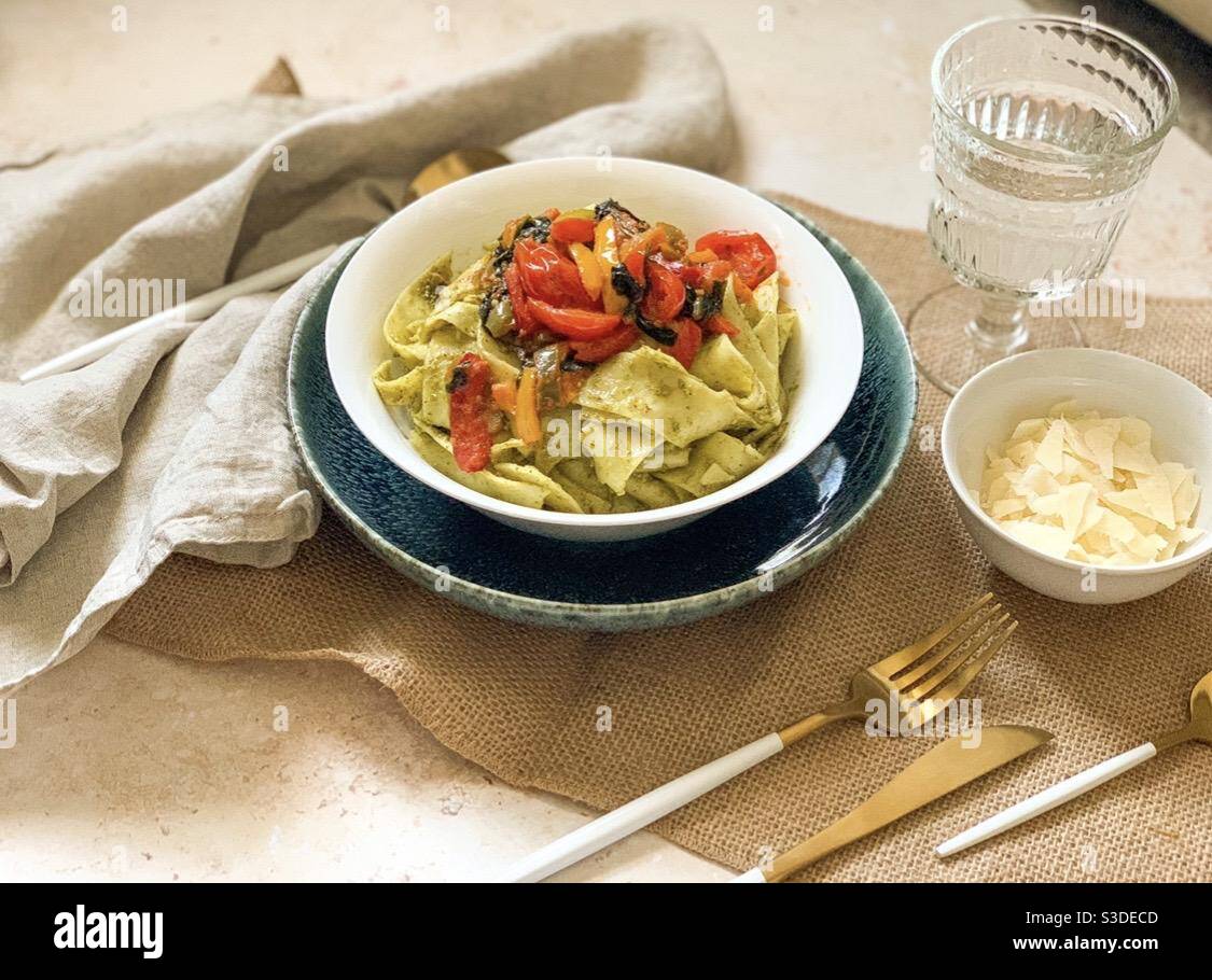 Photograph of pasta dish with table setting and cutlery Stock Photo Alamy