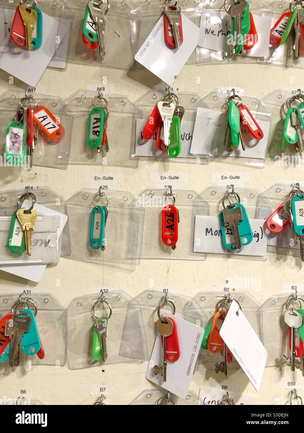 rows of keys and labels hanging up in an organised manner with copy space - Smartphone Captured Stock Image