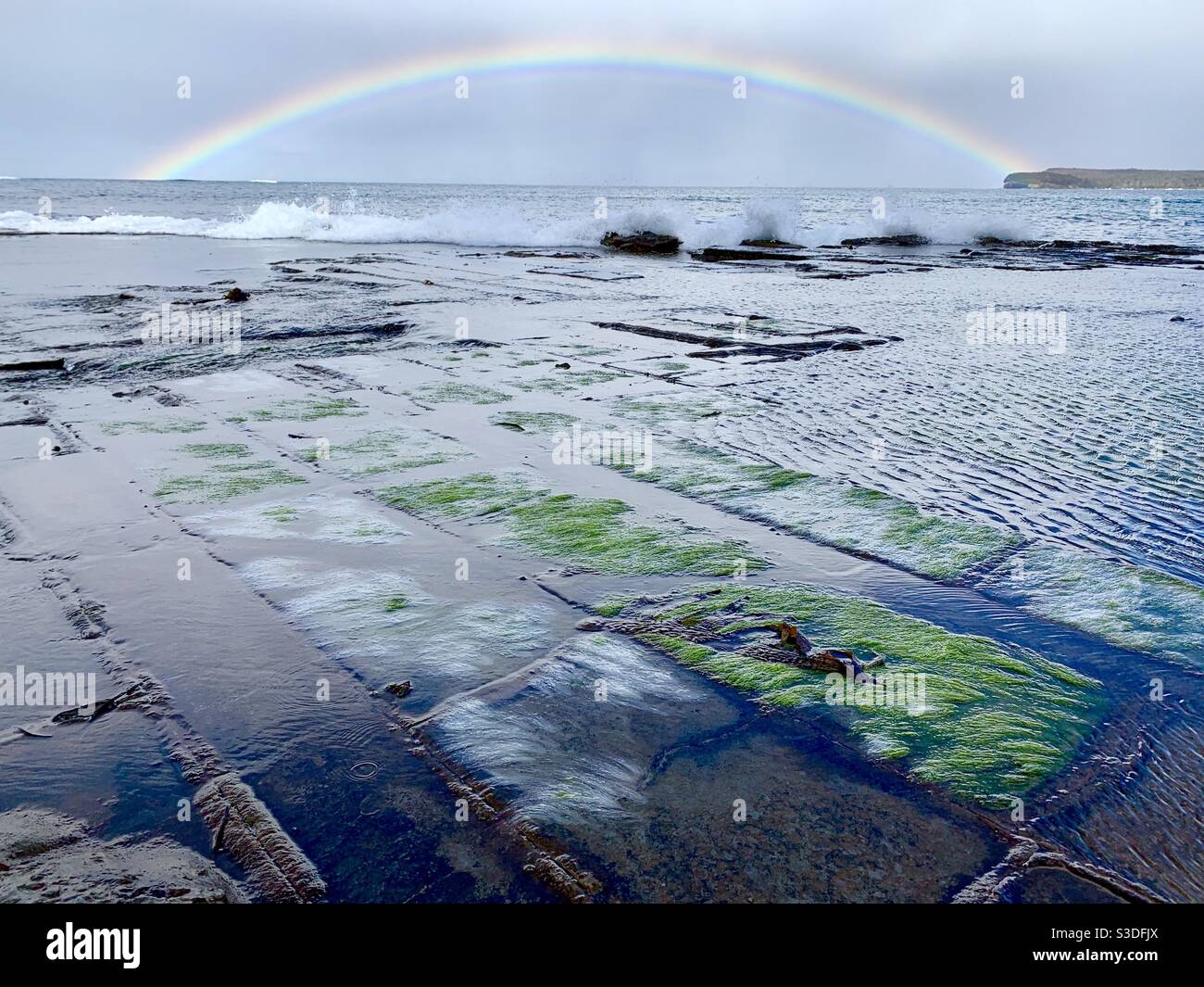 Rainbow at the Tessellated Pavement, Tasman Peninsula, Tasmania Stock Photo