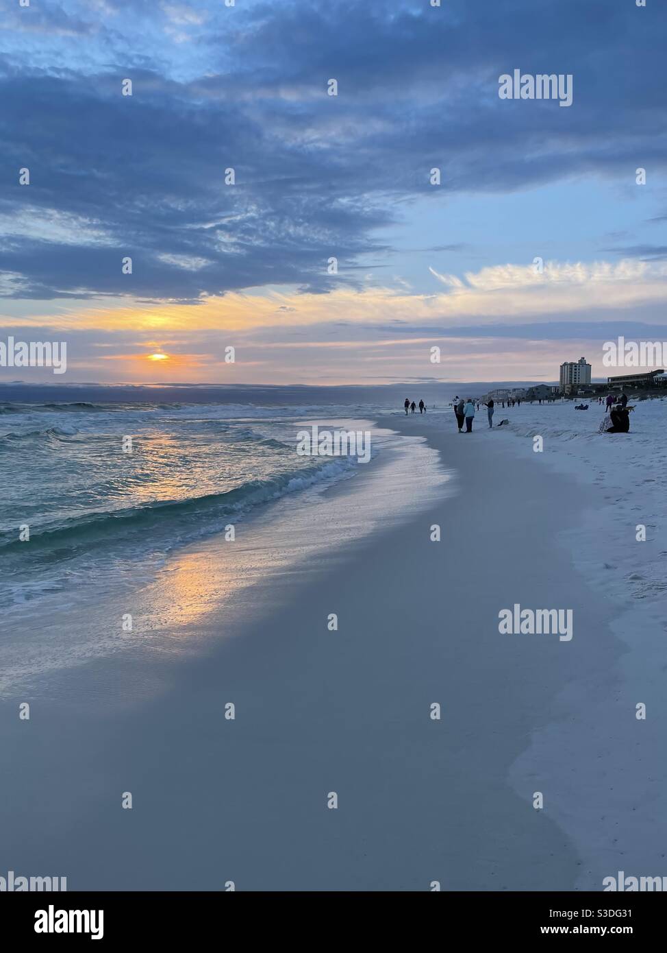 February 15, 2021 Destin, Florida USA People gathered on a chilly winter day to watch sunset on the beach Stock Photo