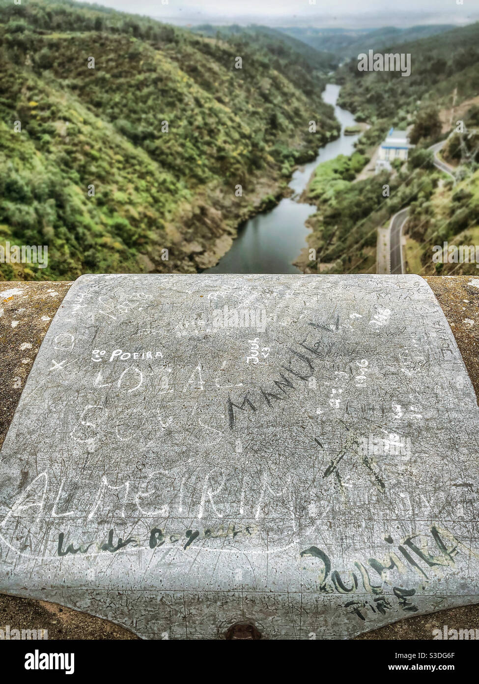 Names graffitied and carved into the stone bridge above Barragem Castelo Do Bode, Portugal - Smartphone Captured Stock Image