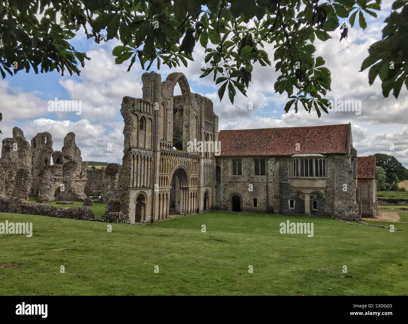 Castle Acre Priory ruins, framed by trees. Near Swaffham, Norfolk, England. Stock Photo