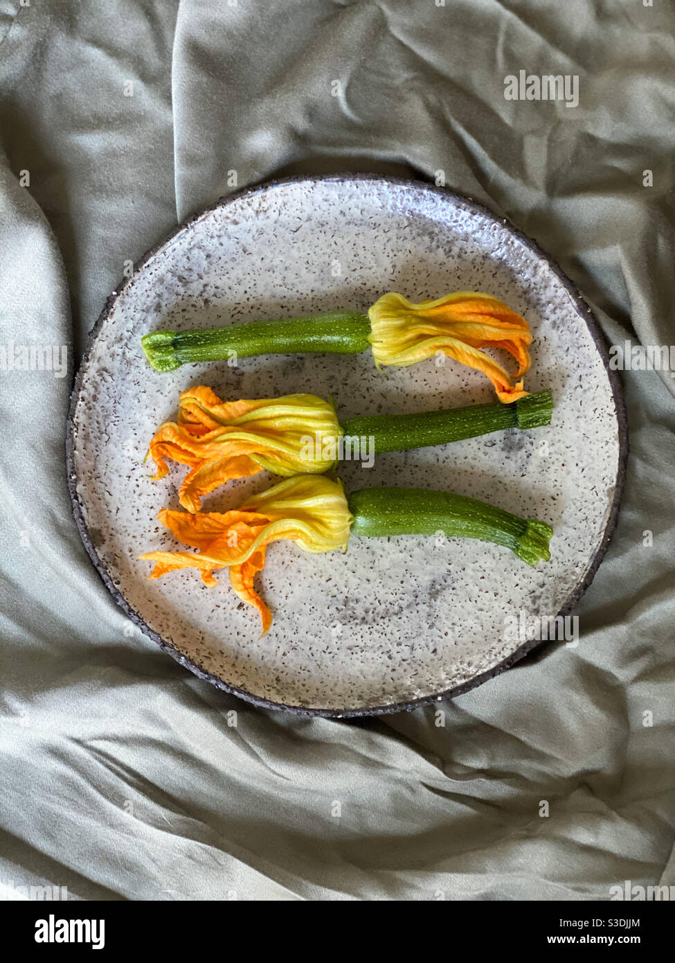 Zucchini flowers on a handmade ceramic plate Stock Photo Alamy