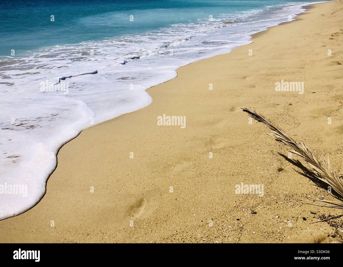 Turquoise sea lining at the beach - Smartphone Captured Stock Image