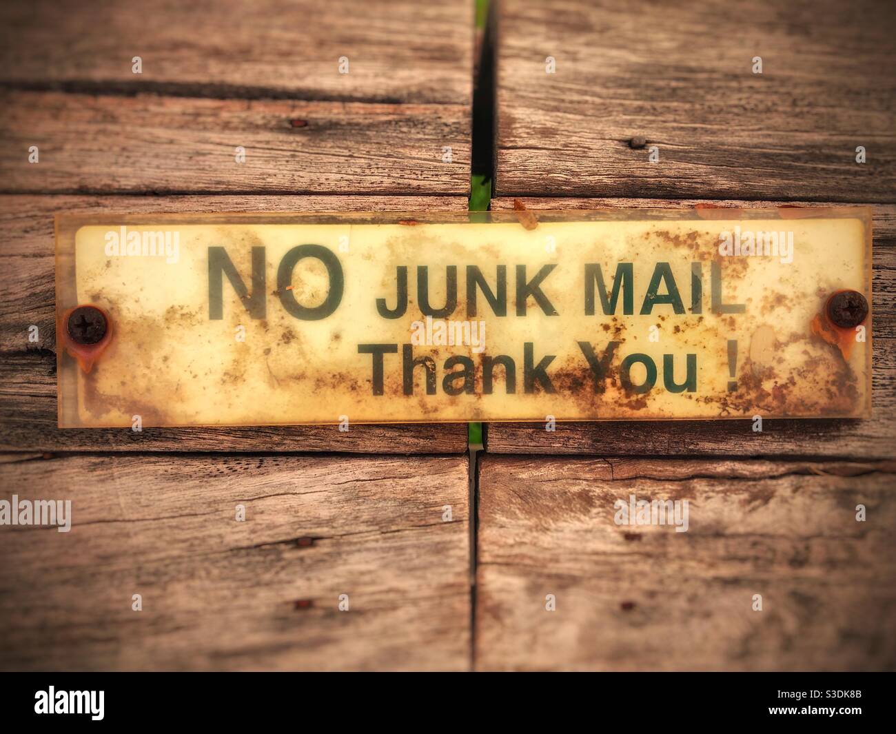 A No junk mail sign on an old timber mailbox - Smartphone Captured Stock Image
