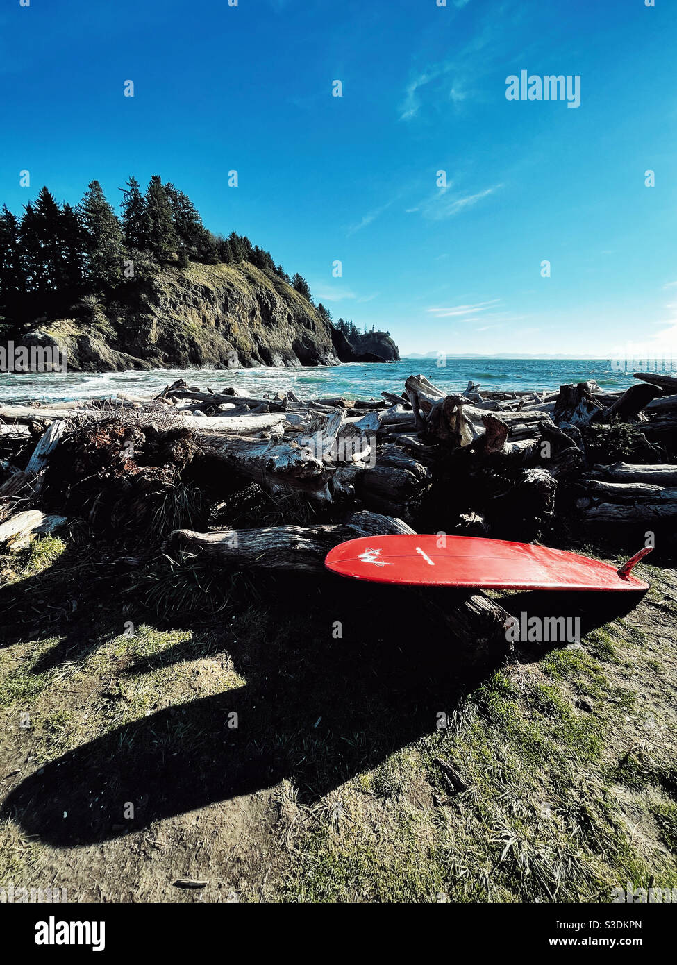 Red surfboard on a shore of Long Beach, WA - Smartphone Captured Stock Image
