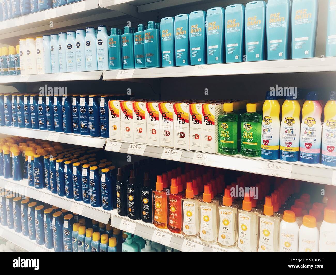 Variety of sun cream products on display at a supermarket Stock Photo
