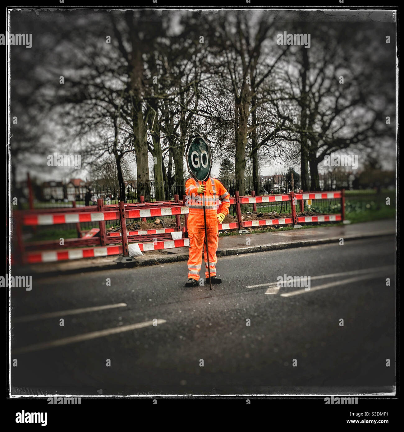 Workman holding GO sign - Smartphone Captured Stock Image
