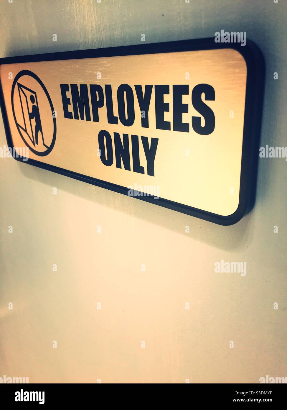 An employees only sign specifically restricts others, United States Stock Photo