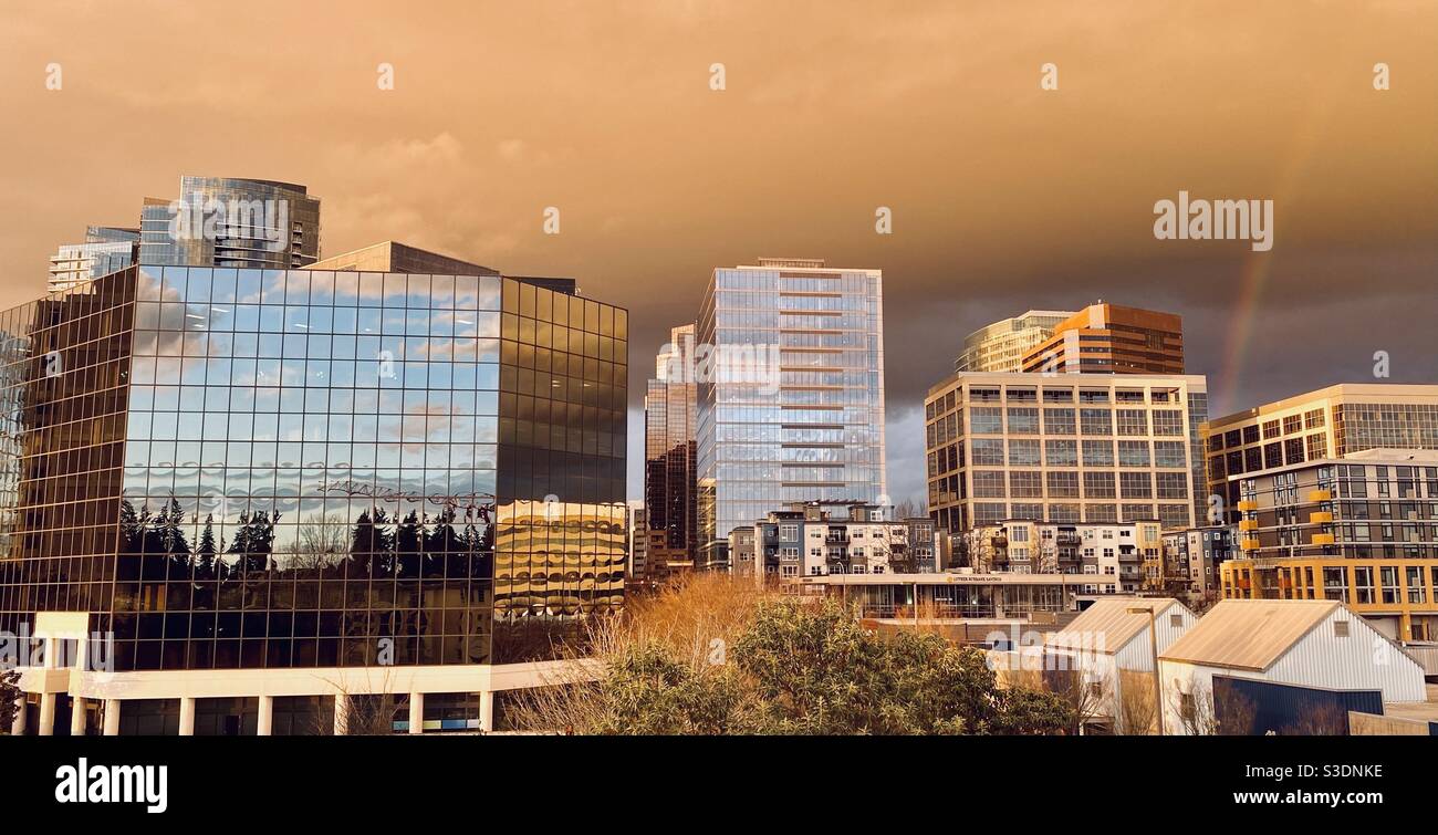 Downtown Bellevue Washington skyline in the cloudy, rainy Pacific Northwest rainbowed evening light - Smartphone Captured Stock Image