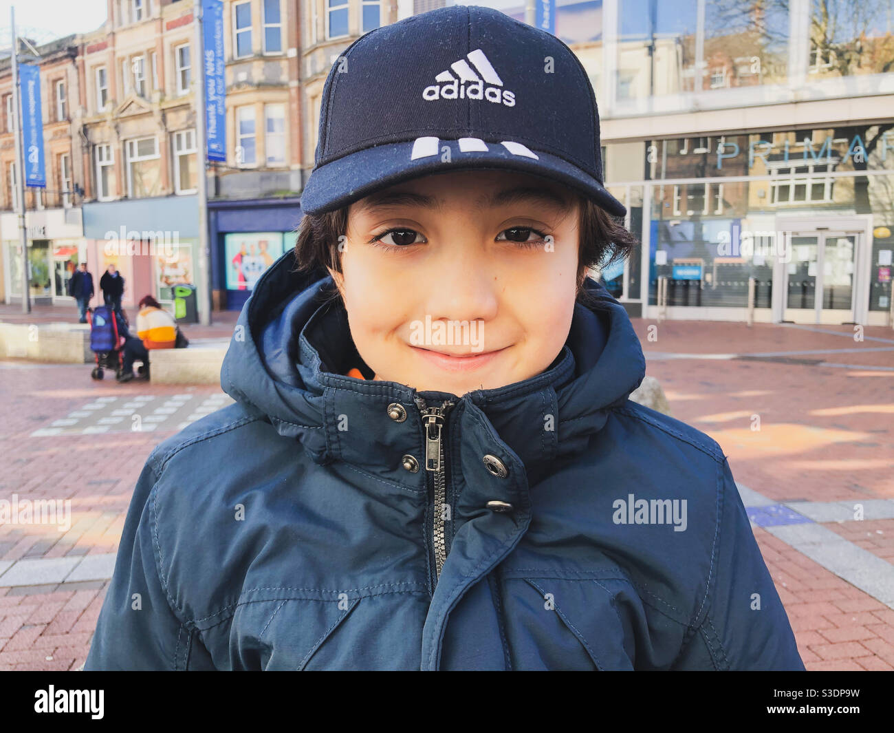 Portrait of a young boy wearing a coat and baseball cap Stock Photo - Alamy