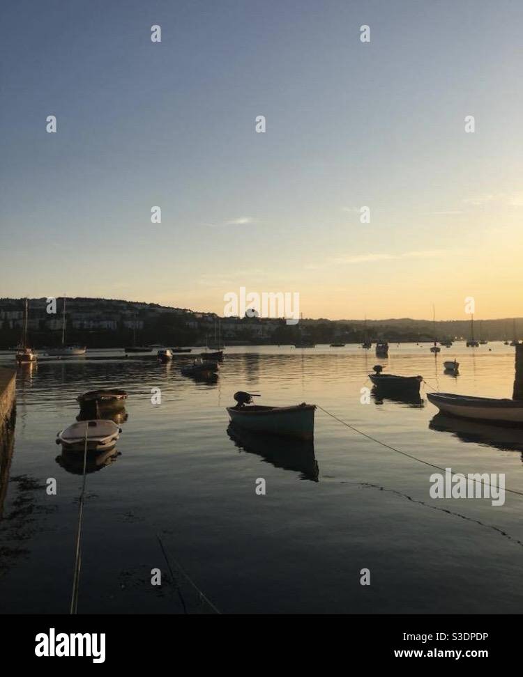 Fishing boats in the sunset Stock Photo - Alamy