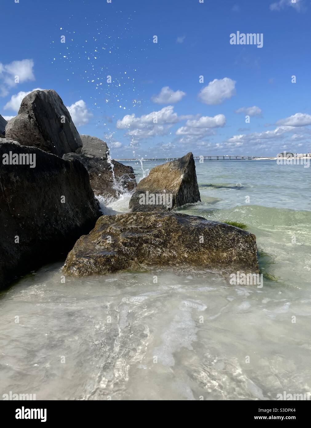 Ocean water crashing against rocky jetties on Florida beach - Smartphone Captured Stock Image