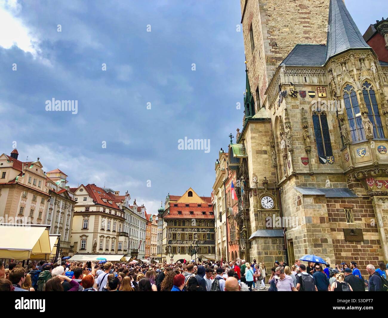 Crowd of people and tourists watching Astronomical Clock built in 15th century at Old Town square in Prague, Czech Republic. - Smartphone Captured Stock Image