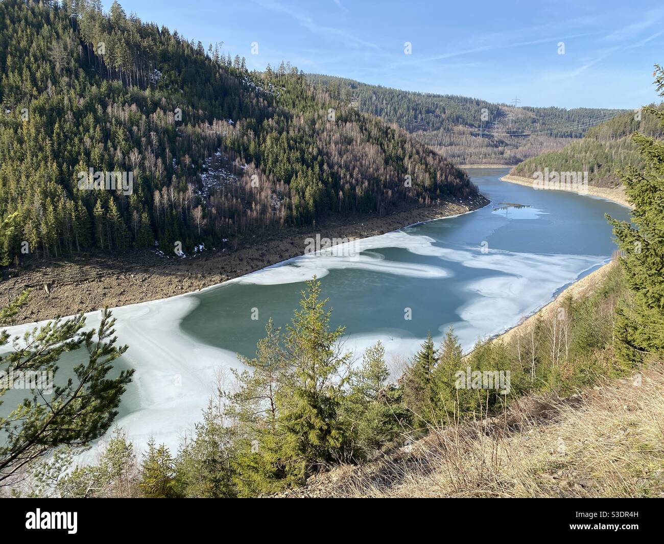 Wintry landscape with frozen river on a sunny winter day Stock Photo