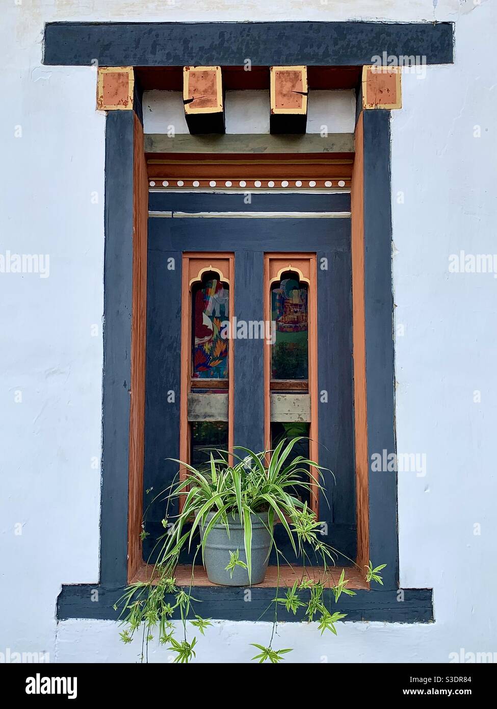 A window with a plant pot in Bhutan Stock Photo