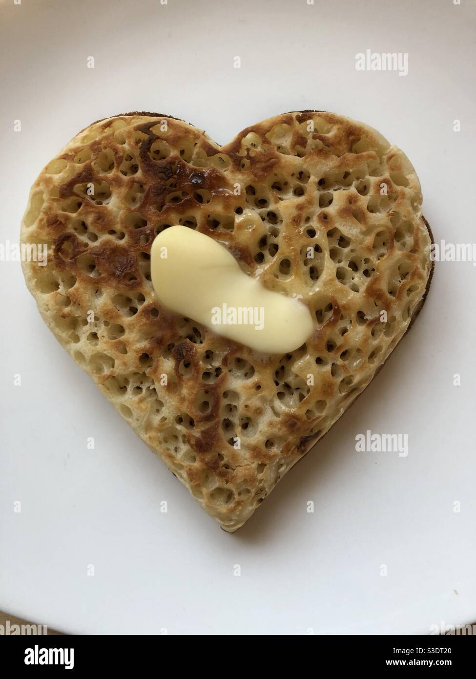 Buttered heart crumpet Stock Photo