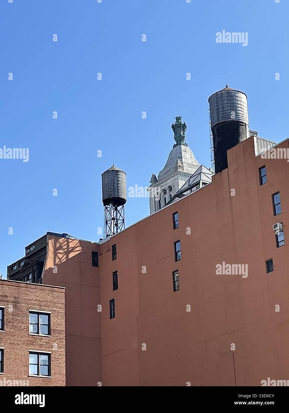 Picturesque vintage water towers on top of old brick buildings in Historic Union Square area of Manhattan, New York, USA - Smartphone Captured Stock Image