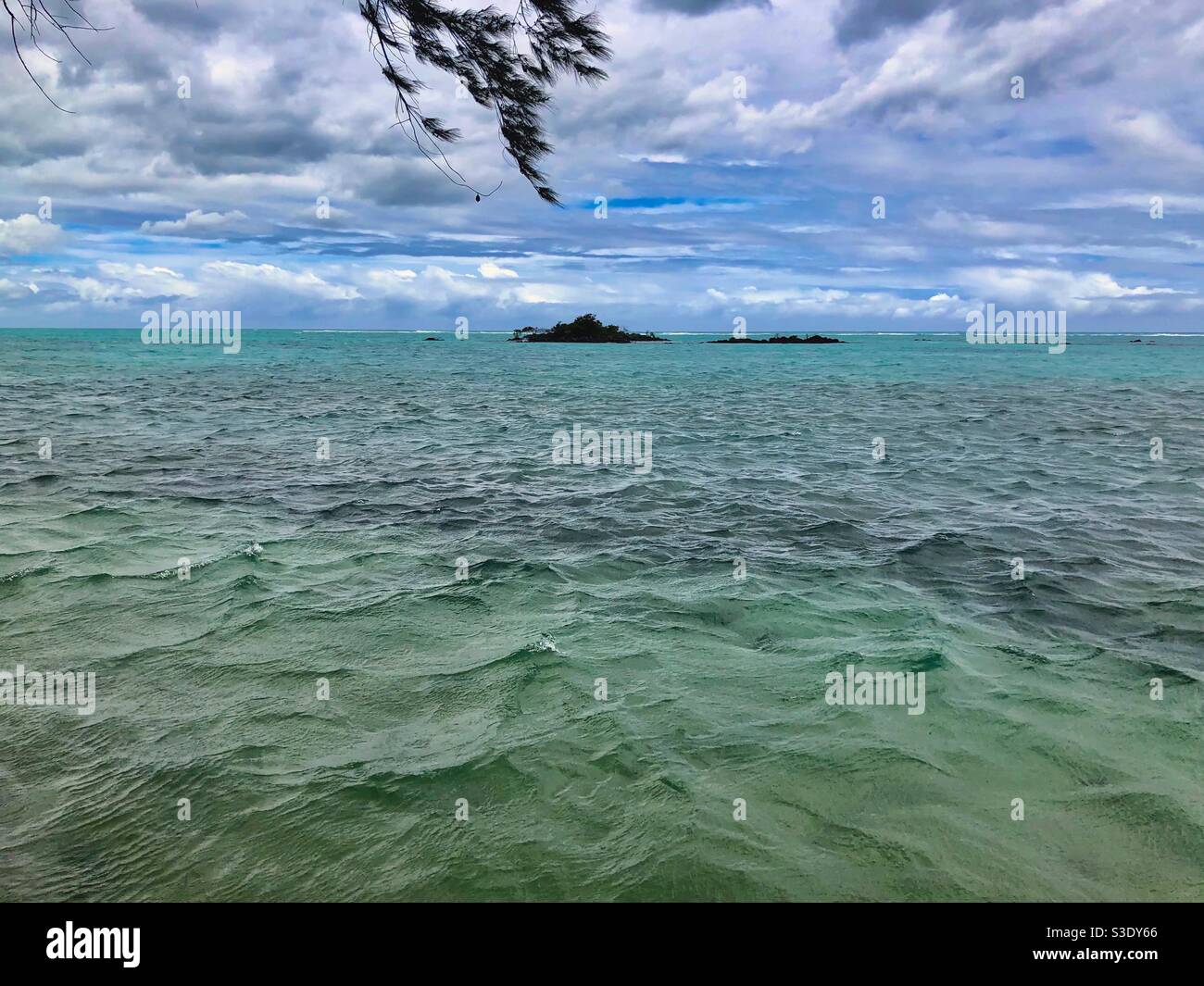 Wavy sea and clouds after the storm on the public beach in Mont Choisy, Mauritius. - Smartphone Captured Stock Image