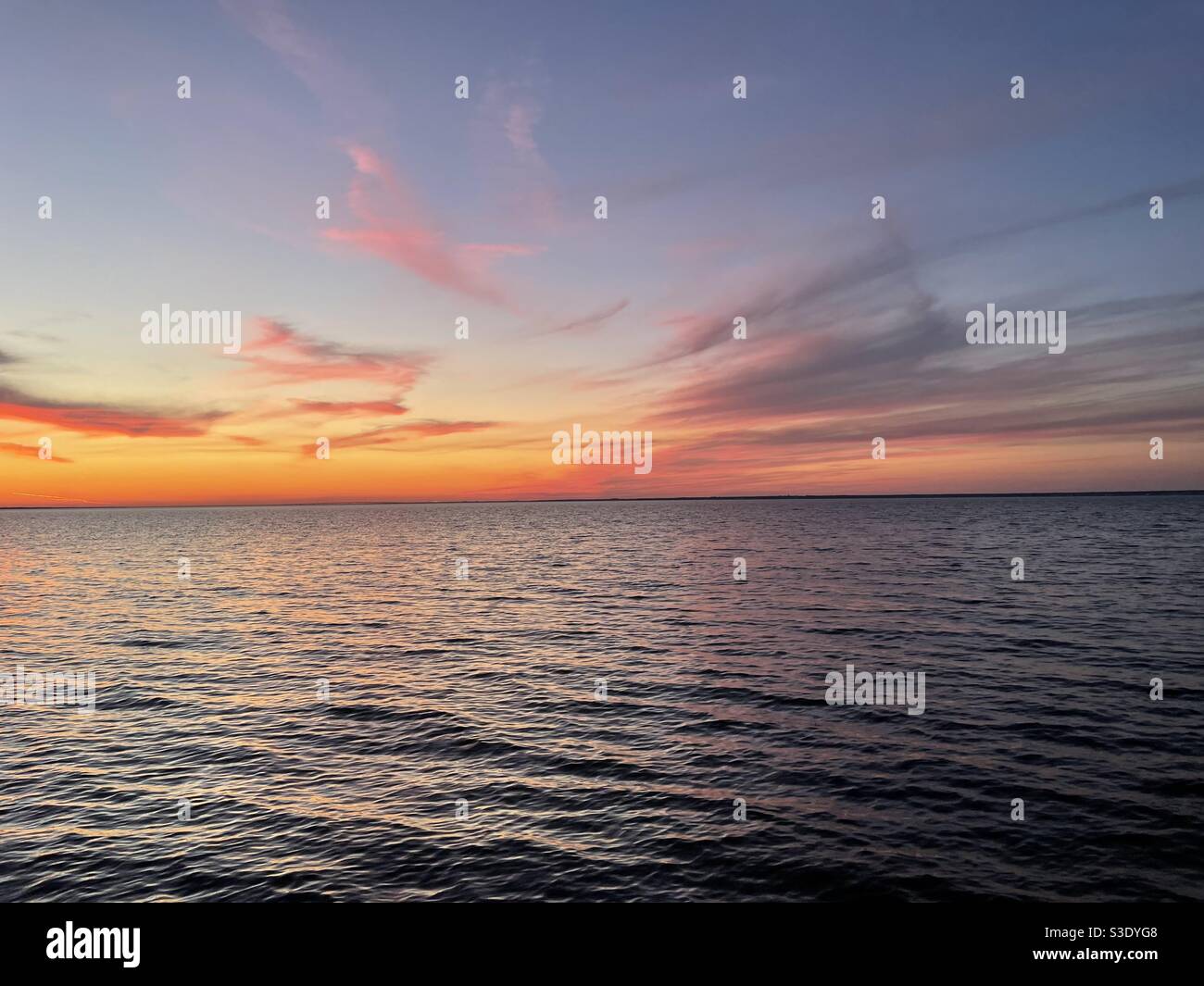 Colorful Florida sunset over bay water - Smartphone Captured Stock Image
