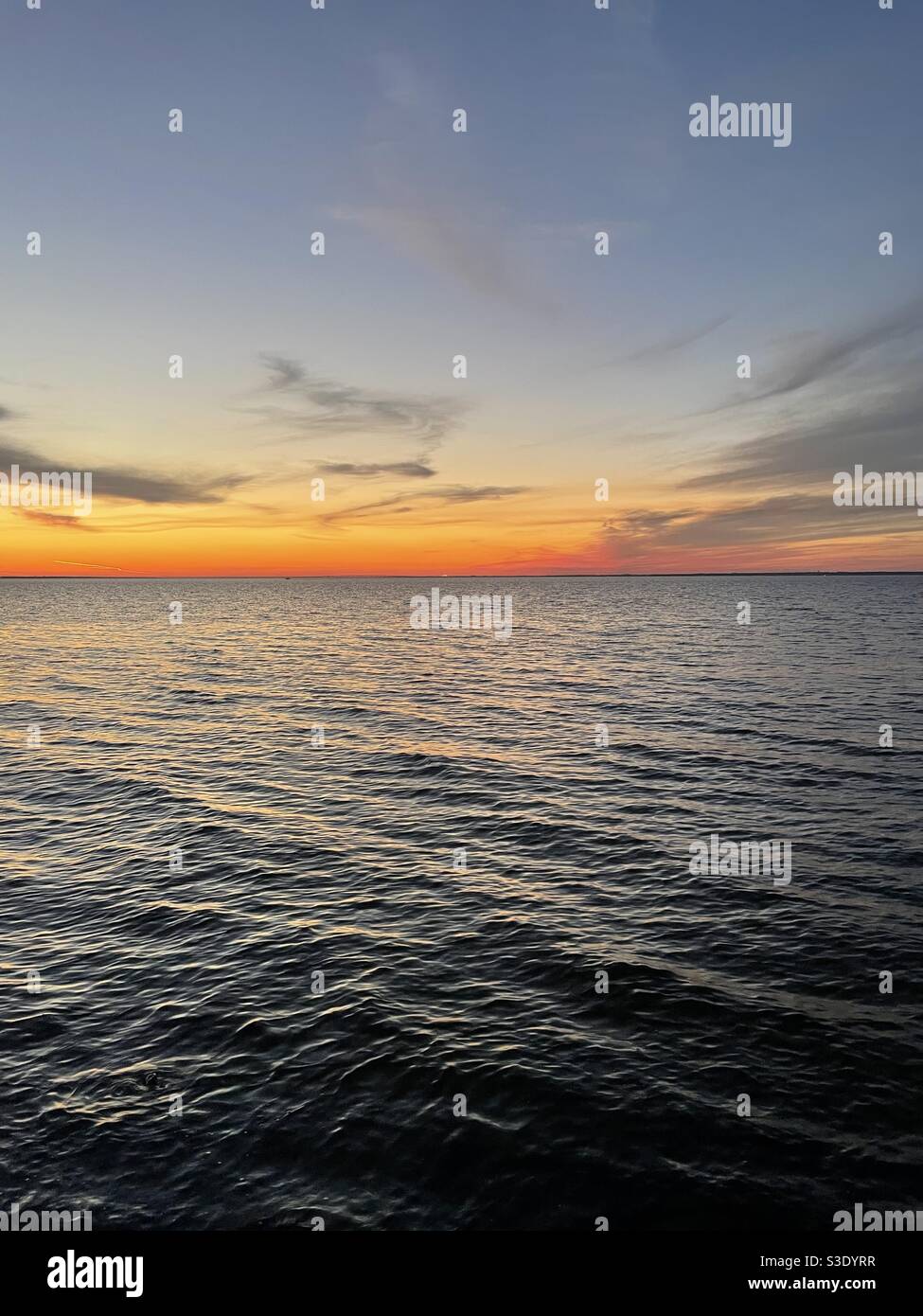 Late evening colorful sunset skies over the Choctawhatchee Bay Florida - Smartphone Captured Stock Image