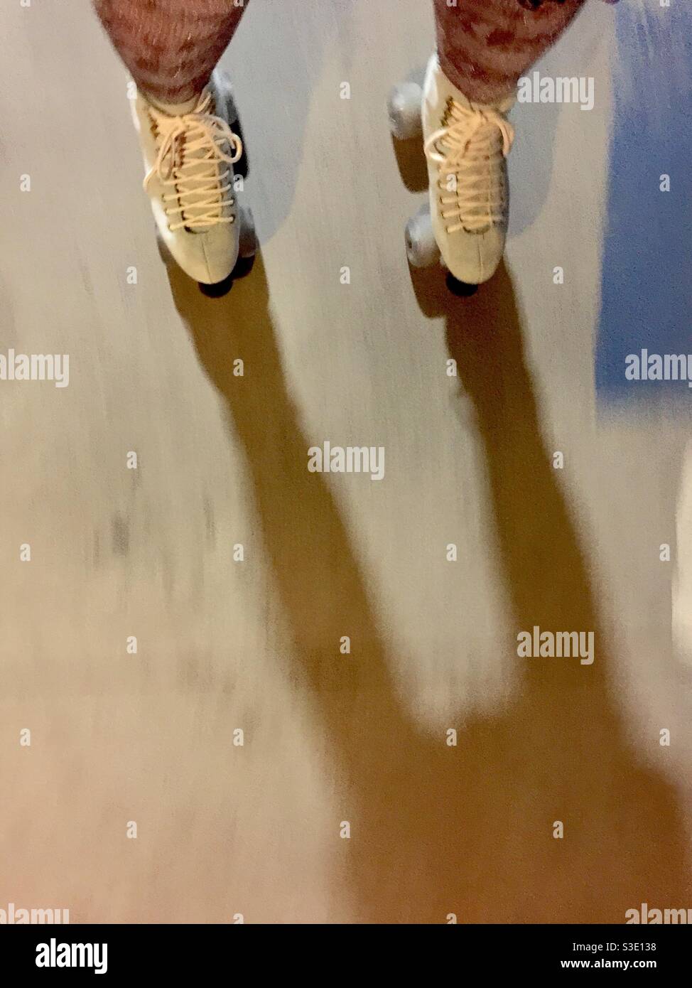 Blue suede roller skates and snakeskin tights. Roller skater POV, point-of-view shot, looking down, in motion. - Smartphone Captured Stock Image