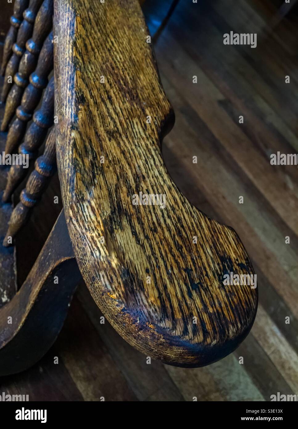 Antique oak chair arm, a curvilinear design on an easy chair, hoary with age, natural, unpainted finish, Nova Scotia, Canada. - Smartphone Captured Stock Image