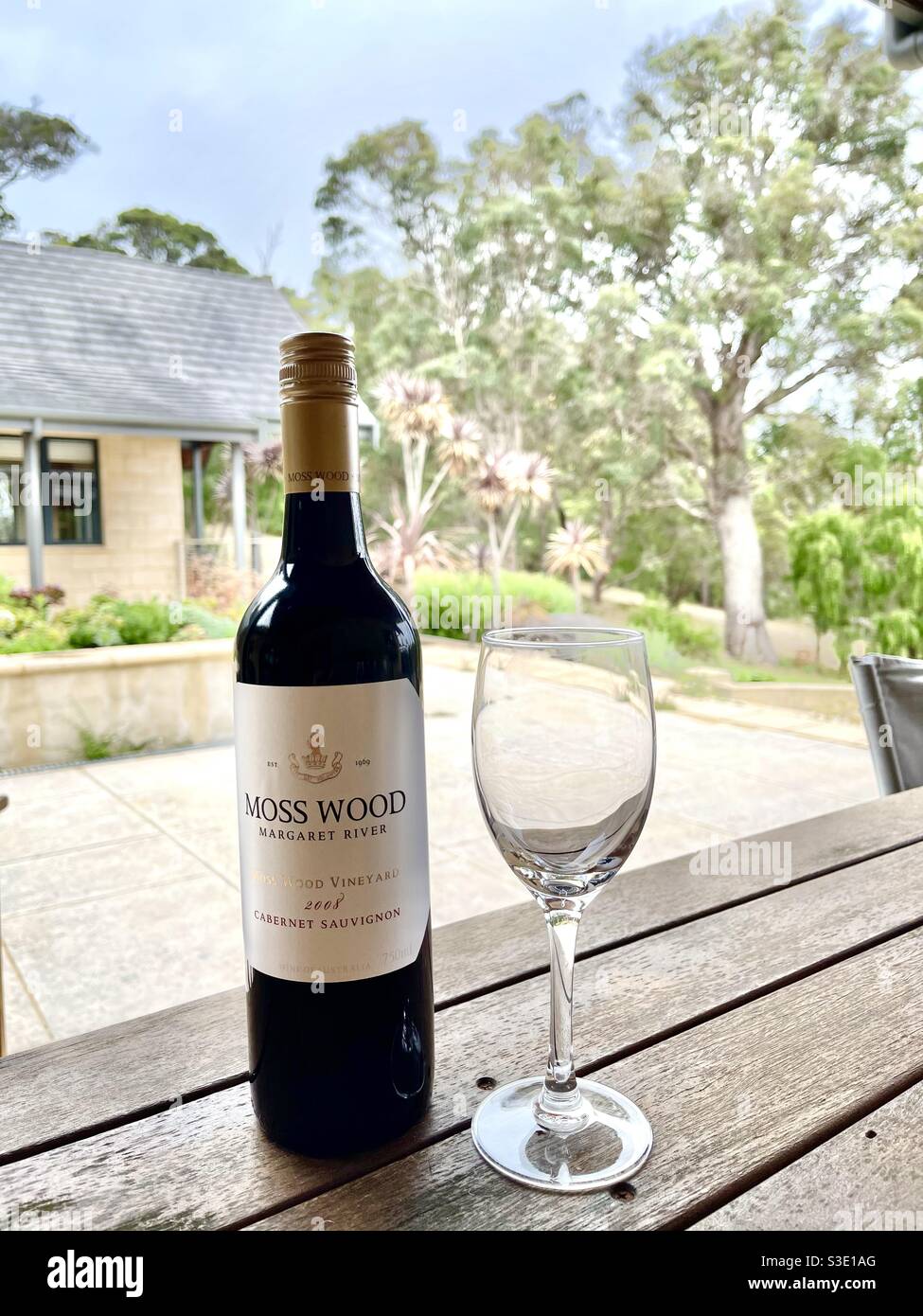 Wine glass next to a bottle of red wine Moss Wood Cabernet Sauvignon Margaret River Western Australia Stock Photo