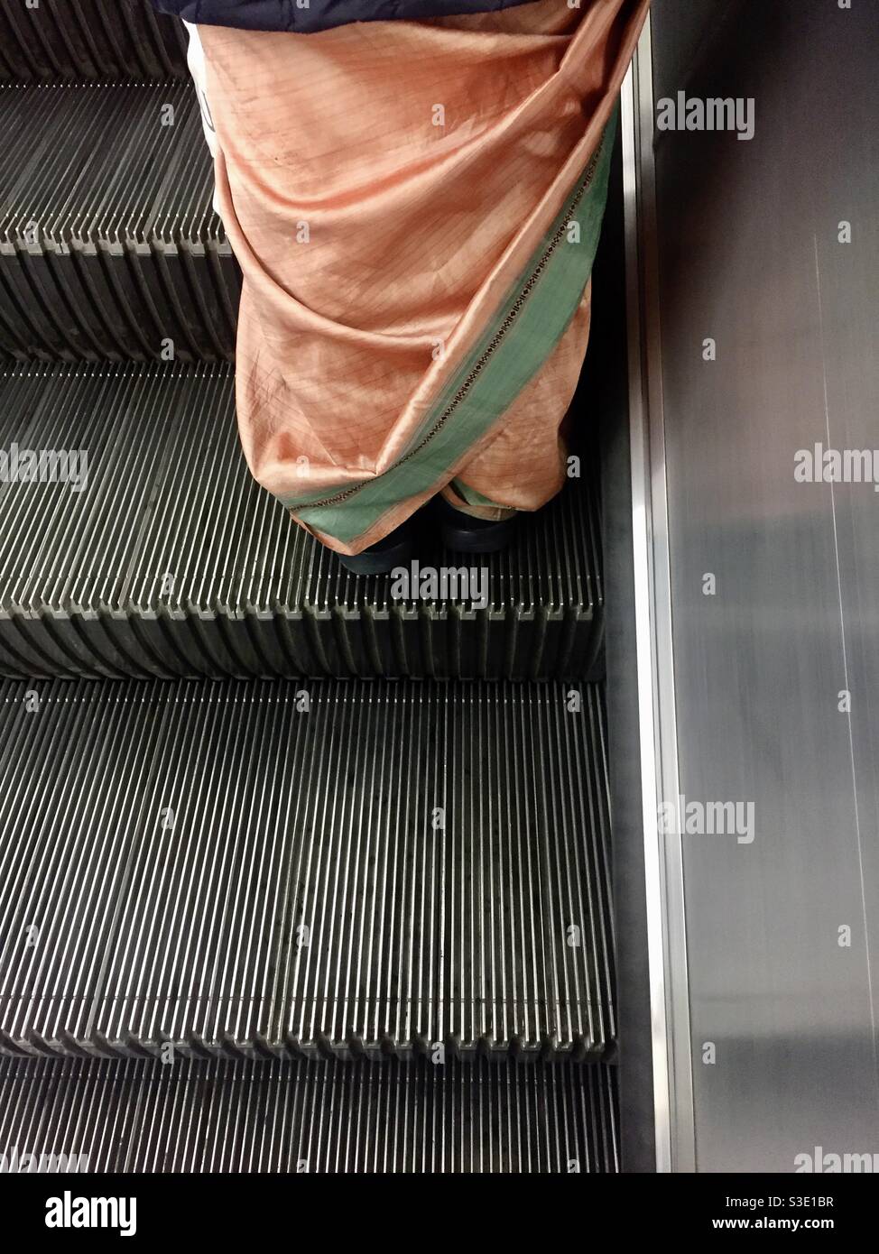 Sari on escalator - Smartphone Captured Stock Image