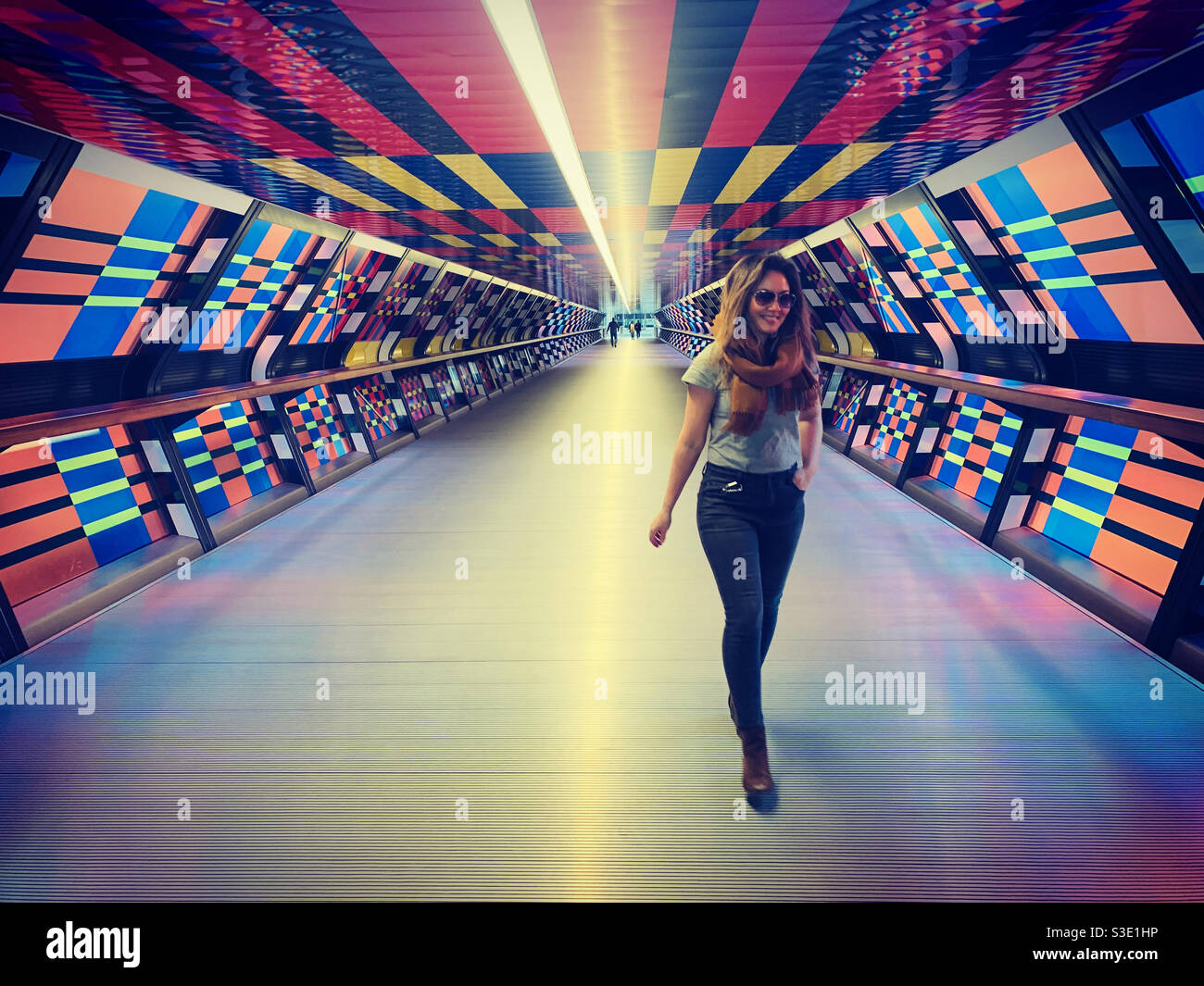 Woman walking through cross rail tunnel in Canary Wharf - Smartphone Captured Stock Image