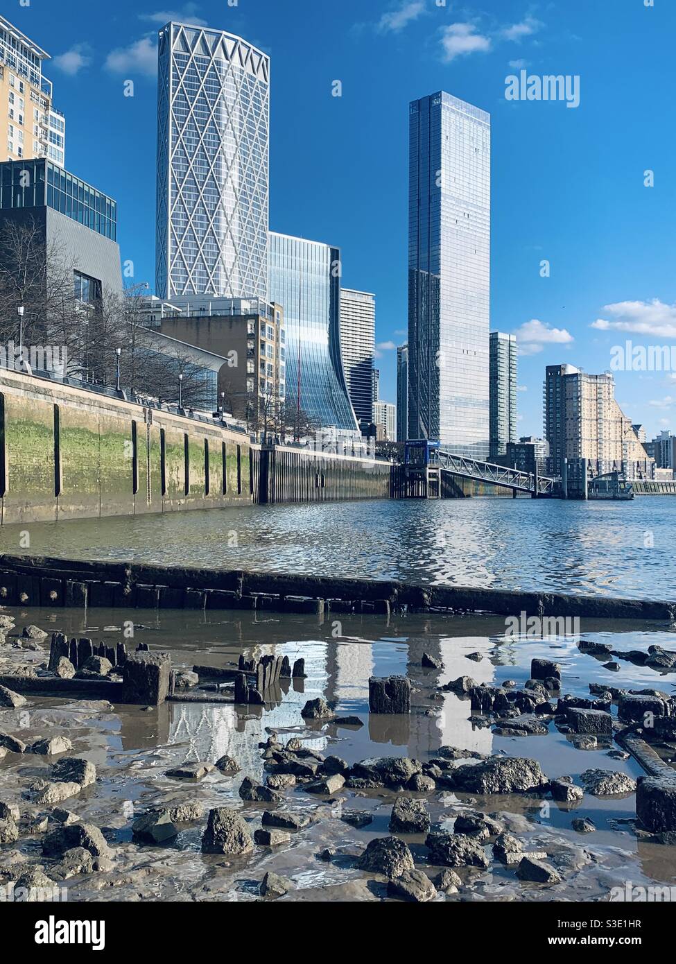 Canary Wharf from the river bank on a sunny day - Smartphone Captured Stock Image