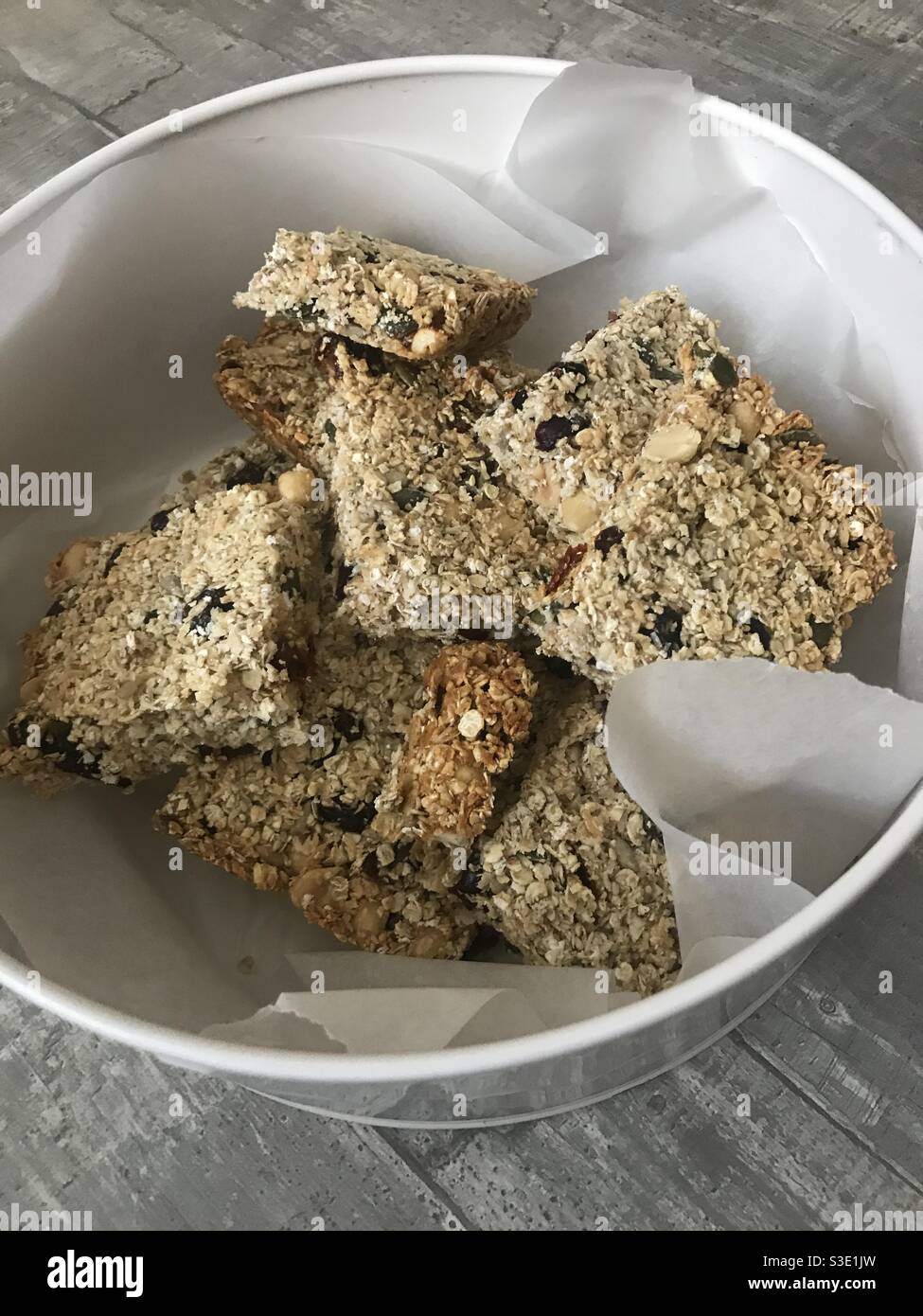 Closeup image of homemade breakfast cereal bars in a tin Stock Photo