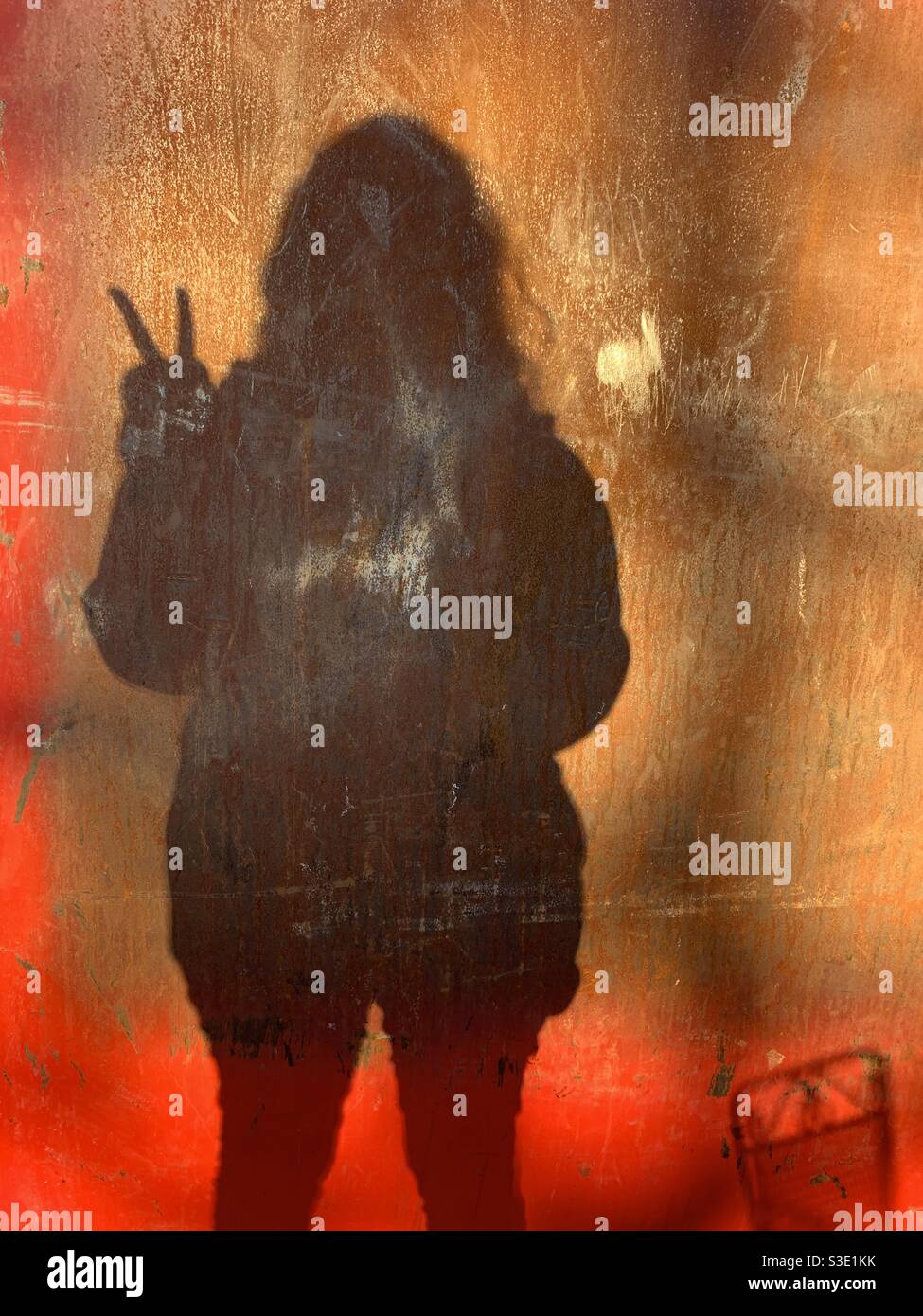 A person throwing a peace symbol silhouetted Stock Photo Alamy